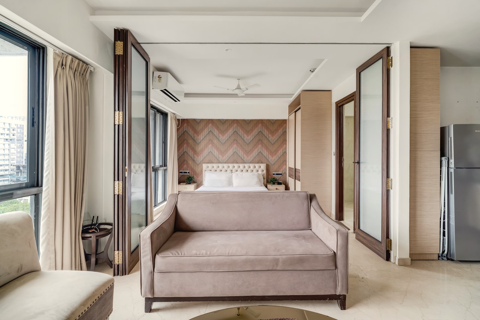 The living room at Amalfi, BKC, with the city beyond the window
